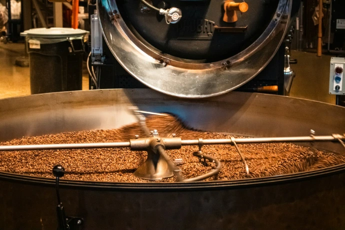 Roasted coffee beans mixing in a large machine